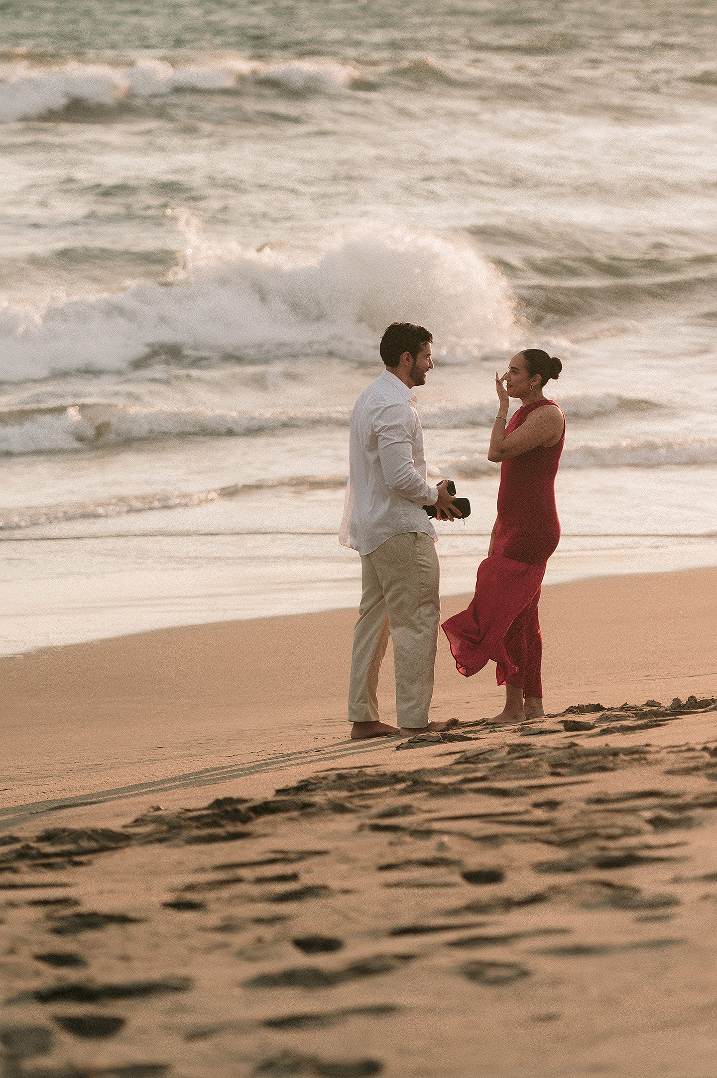 Carlos muestra el anillo a Carolina, haciendole una propuesta en la playa de Mazatlán.