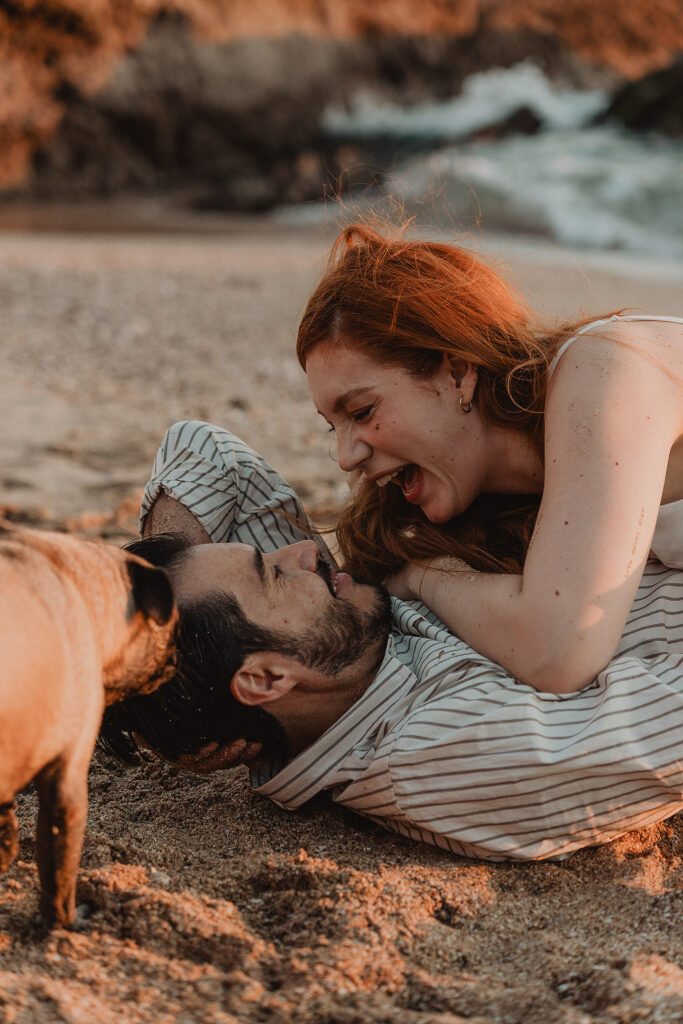 Sesión de pareja en Mazatlán de Xiomara y Alejandro junto al mar en la arena sonriendo
